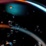 Macro of colorful oil droplets in water